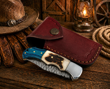 Load image into Gallery viewer, Hand Forged Damascus Pocket Knife – Engraved Folding Knife with Stag Horn &amp; Blue Pakka Wood Handle