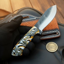 Load image into Gallery viewer, Orange Swirl Resin Rasp Skinner Knife with Tooled Leather Sheath