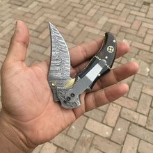 Load image into Gallery viewer, Damascus Recurve Folding Pocket Knife — Liner Lock, Black Resin &amp; Wood Handle, Brass Spacer &amp; Pocket Clip