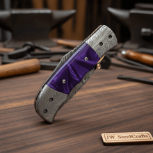 Load image into Gallery viewer, Handmade Feather Pattern Damascus Folding Knife with Purple Resin Handle &amp; Leather Sheath