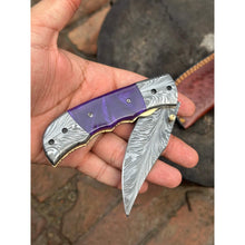 Load image into Gallery viewer, Handmade Feather Pattern Damascus Folding Knife with Purple Resin Handle &amp; Leather Sheath